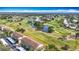 Expansive aerial shot of the condo community overlooking a meticulously maintained golf course and serene pond at 839 Wexford Blvd # 839, Venice, FL 34293