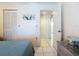 Bright bedroom with tile flooring, a closet, and a view into the hallway at 839 Wexford Blvd # 839, Venice, FL 34293