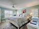 Bright bedroom featuring a floral comforter, plantation shutters, and a ceiling fan at 839 Wexford Blvd # 839, Venice, FL 34293