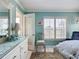 Inviting bedroom showcasing a comfortable chair, plantation shutters, and a cozy rug at 839 Wexford Blvd # 839, Venice, FL 34293