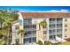 Close-up exterior highlighting the condo's private screened patio and tropical landscaping at 839 Wexford Blvd # 839, Venice, FL 34293