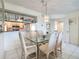 Bright dining room featuring chandelier lighting and convenient pass-through to the kitchen at 839 Wexford Blvd # 839, Venice, FL 34293
