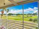 Screened-in porch offering picturesque view of golf course, lake, and blue skies with clouds at 839 Wexford Blvd # 839, Venice, FL 34293