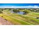 Scenic golf course view featuring lush greenery, mature trees, and tranquil water hazards creating a picturesque landscape at 839 Wexford Blvd # 839, Venice, FL 34293
