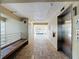 Well-maintained hallway featuring elevator access and comfortable seating, leading to condo units at 839 Wexford Blvd # 839, Venice, FL 34293