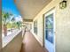 Exterior hallway with a neutral color scheme and a view of the grounds and palm trees at 839 Wexford Blvd # 839, Venice, FL 34293