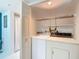 Practical laundry area with a washer, dryer, and overhead storage, providing convenience and organization at 839 Wexford Blvd # 839, Venice, FL 34293