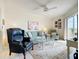 Comfortable living room with plush seating, a ceiling fan, and access to a screened patio with a view at 839 Wexford Blvd # 839, Venice, FL 34293