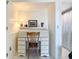 Charming office nook with a roll-top desk, decorative items, and access to the adjacent bathroom at 839 Wexford Blvd # 839, Venice, FL 34293