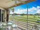 Screened patio with glass table and seating that showcases an expansive golf course view at 839 Wexford Blvd # 839, Venice, FL 34293
