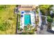 Aerial view of a community pool with lounge chairs and tropical landscaping at 839 Wexford Blvd # 839, Venice, FL 34293