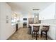 Bright white kitchen featuring stainless steel appliances, ample storage, and a convenient breakfast bar at 8432 Culebra Ave, North Port, FL 34287