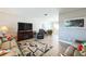 Comfortable living space with an open layout, including a TV, comfortable seating, and access to other areas at 8432 Culebra Ave, North Port, FL 34287