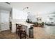 Open-concept living area with a kitchen island, dining space, and comfortable seating arrangement at 8432 Culebra Ave, North Port, FL 34287