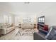 Inviting living room featuring neutral tones, stylish decor, and a large television for entertainment at 8432 Culebra Ave, North Port, FL 34287