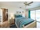 Serene main bedroom featuring stylish bedding, natural light, and access to outdoor patio at 8432 Culebra Ave, North Port, FL 34287