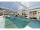 Inviting screened-in pool area with ample seating, perfect for relaxing and entertaining guests in style at 8432 Culebra Ave, North Port, FL 34287