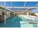 Enclosed pool with covered lounge area, offering a private and comfortable outdoor experience for relaxation and leisure at 8432 Culebra Ave, North Port, FL 34287