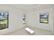 Sunny bedroom with three windows, neutral carpeting, and a ceiling fan for added comfort at 846 Senda Plata # 26, Venice, FL 34293