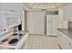 Spacious kitchen featuring a white refrigerator, tile flooring, and ample cabinet space at 846 Senda Plata # 26, Venice, FL 34293