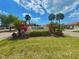 The 'Vivienda' community sign is surrounded by colorful foliage and manicured landscaping, adding to the welcoming atmosphere at 846 Senda Plata # 26, Venice, FL 34293