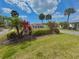 The 'Vivienda' community sign is surrounded by colorful foliage and manicured landscaping, adding to the welcoming atmosphere at 846 Senda Plata # 26, Venice, FL 34293