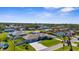 Beautiful aerial view of a well maintained single story home with large lawn, three car garage, and manicured landscaping at 863 Southland Rd, Venice, FL 34293