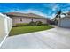 The backyard of this home has a lush lawn, garden and a detached garage at 863 Southland Rd, Venice, FL 34293