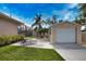 Backyard with a detached garage, lounging chairs and a screened-in porch at 863 Southland Rd, Venice, FL 34293