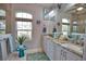 Beautiful bathroom features a double sink vanity with granite counters and a unique nautical themed mirror at 863 Southland Rd, Venice, FL 34293