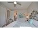 Bedroom with decorative iron bed frame, coastal decor, ceiling fan and natural light at 863 Southland Rd, Venice, FL 34293