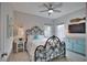 Bedroom featuring a decorative iron bed frame, coastal decor, ceiling fan and natural light at 863 Southland Rd, Venice, FL 34293