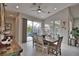 Open dining area with tile floors, modern ceiling fan, sliding glass doors and an adjacent patio with pool at 863 Southland Rd, Venice, FL 34293