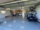 Spacious garage with epoxy flooring and a golf cart at 863 Southland Rd, Venice, FL 34293