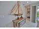 Hallway area decorated with model sailboat on rustic table and chest at 863 Southland Rd, Venice, FL 34293