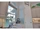 Bright kitchen area with stone countertops, tile backsplash, modern appliances, and natural light from large window at 863 Southland Rd, Venice, FL 34293