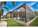 Screened lanai featuring a pool and umbrella-covered outdoor dining set at 863 Southland Rd, Venice, FL 34293