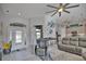 Bright living room with tile flooring, comfortable seating, and an open view to the kitchen area with modern appliances at 863 Southland Rd, Venice, FL 34293