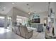 Open-concept living room with modern decor, a comfortable sofa, and sliding glass doors leading to the screened-in pool area at 863 Southland Rd, Venice, FL 34293