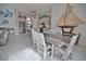 Open-concept living area featuring tile floors, dining space, kitchen with island, and comfortable seating area at 863 Southland Rd, Venice, FL 34293