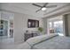 Enjoy this bright main bedroom with a king bed, en-suite bathroom, tray ceilings and slider to screened in pool at 863 Southland Rd, Venice, FL 34293
