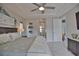 Comfortable main bedroom with king bed, en-suite bathroom, tray ceiling, ceiling fan and light nautical decorations at 863 Southland Rd, Venice, FL 34293