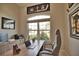 Well-lit home office featuring a large window, comfortable seating, and sports memorabilia art at 863 Southland Rd, Venice, FL 34293