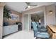 Outdoor covered kitchen with granite countertops, a sink, grill, bar seating, and view to the pool at 863 Southland Rd, Venice, FL 34293