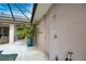 Private outdoor shower area with a lush tropical plant and access to the pool area at 863 Southland Rd, Venice, FL 34293