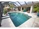 Beautiful in-ground pool with a screened enclosure, patio area and access to a covered outdoor kitchen at 863 Southland Rd, Venice, FL 34293