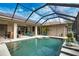 Backyard pool with screened enclosure, solar panels, and covered seating area perfect for Florida outdoor living at 863 Southland Rd, Venice, FL 34293