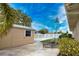 Exterior view of storage shed with lounge chairs and palm trees at 863 Southland Rd, Venice, FL 34293