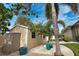 Exterior view of shed, with decorative potted plants and palm trees at 863 Southland Rd, Venice, FL 34293