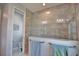 Nicely tiled walk-in shower with a glass partition and coordinated towel bars at 863 Southland Rd, Venice, FL 34293